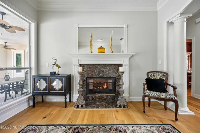 a view of a dining room with furniture a chandelier and window