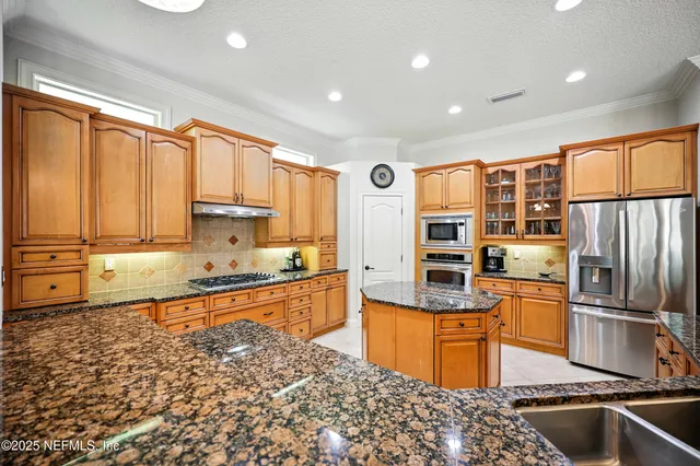 a living room with furniture and kitchen view