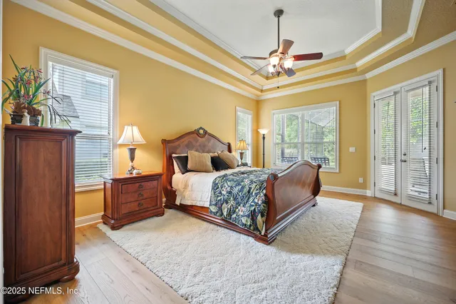 a dining room with furniture and a floor to ceiling window