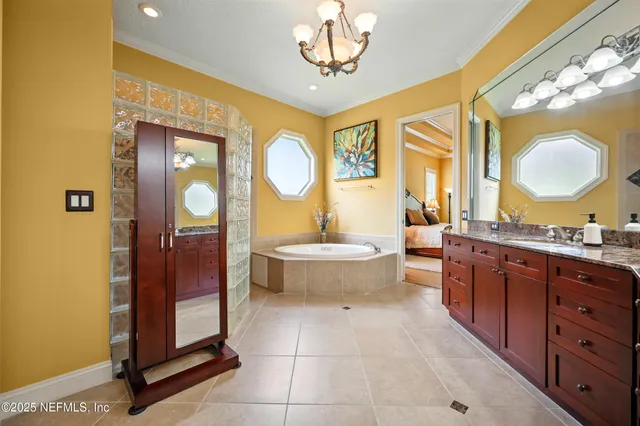 a bathroom with a sink a light fixture and a mirror
