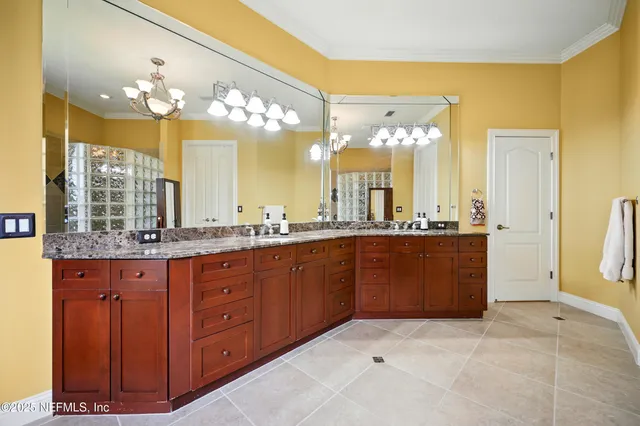 a en suite bathroom with a double vanity sink and a mirror