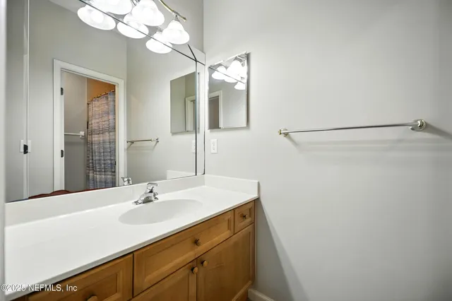 a bedroom with a bed and a dresser with mirror