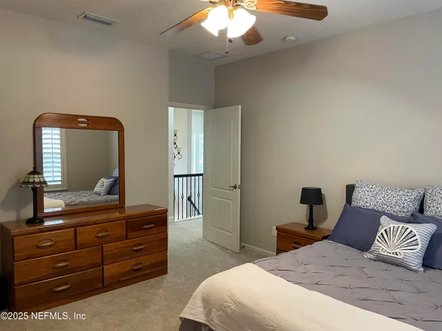 a view of a street with a building and a palm tree