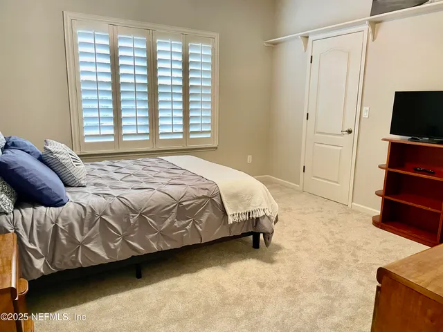 a front view of a residential houses with yard and green space