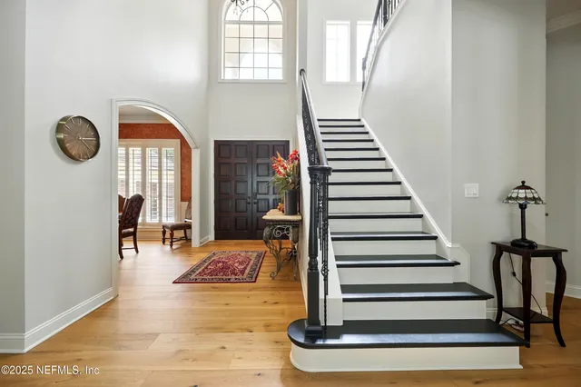 a dining room with furniture a chandelier and wooden floor