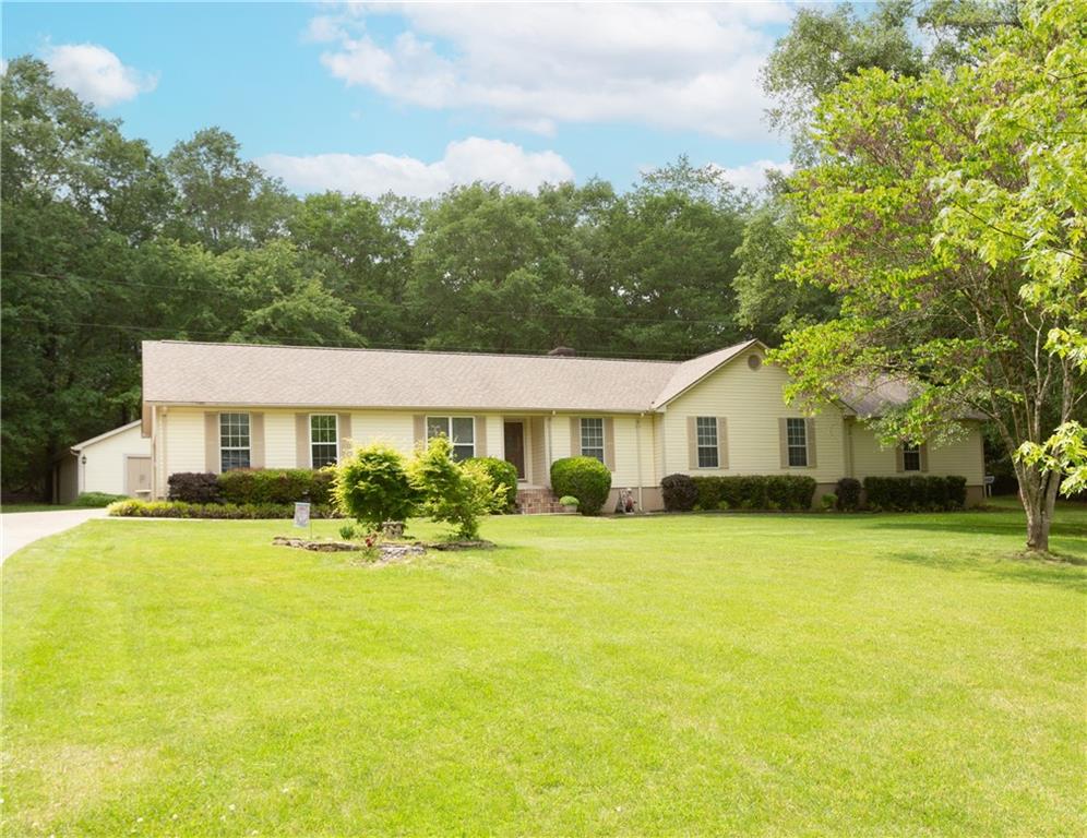 a front view of a house with yard and patio