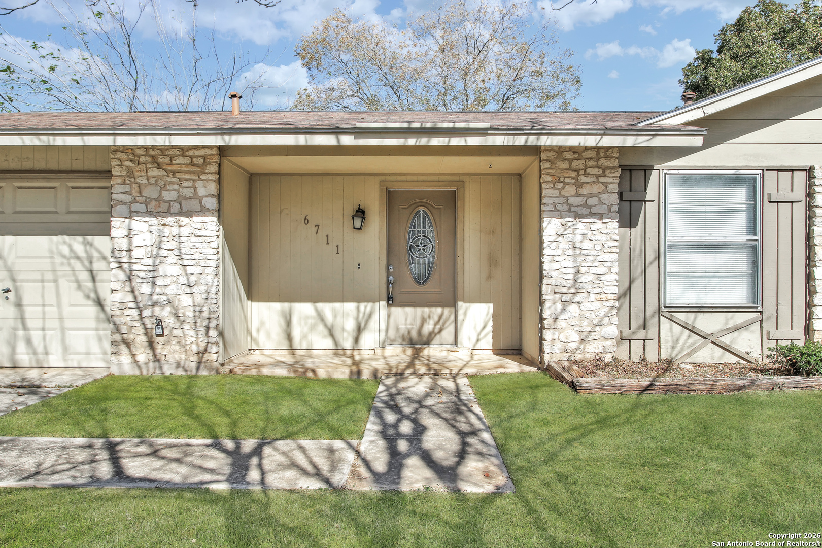 6711 Spring Hollow Street San Antonio, TX 78249 - Photo 3 of 23 a view of a house with a yard
