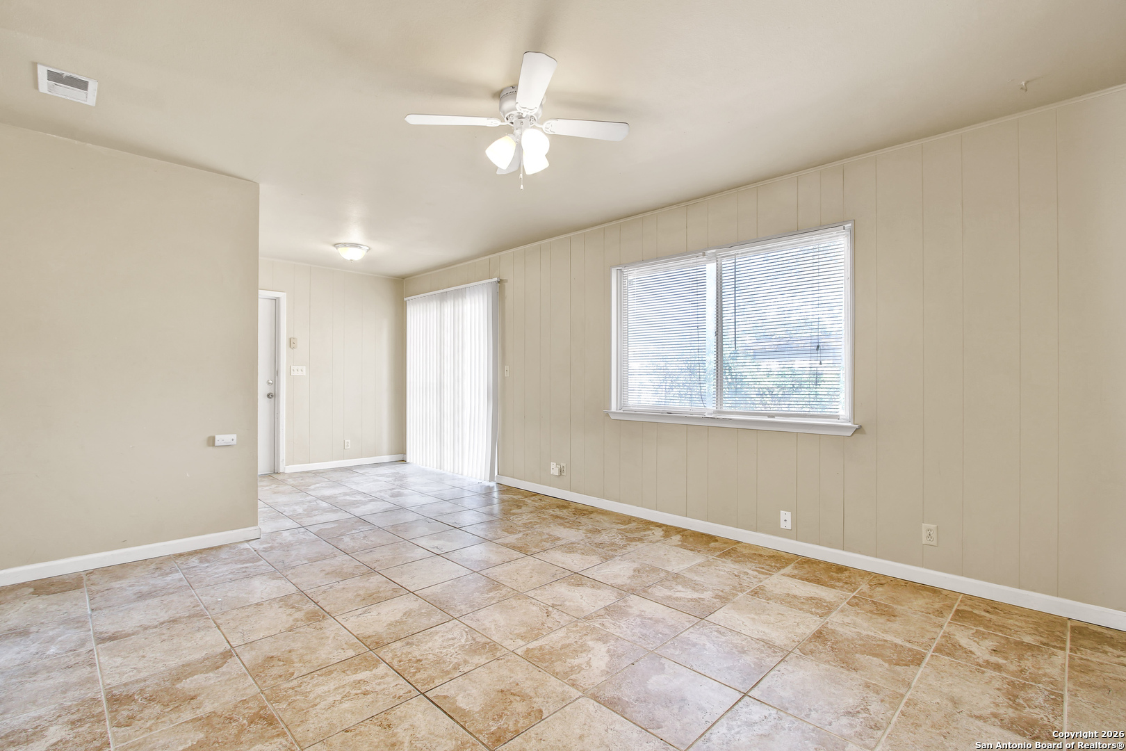6711 Spring Hollow Street San Antonio, TX 78249 - Photo 7 of 23 an empty room with windows and fan