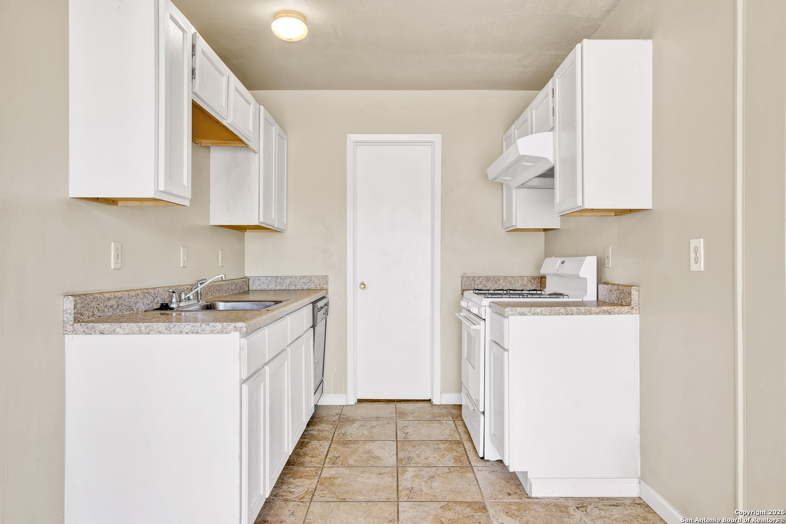 6711 Spring Hollow Street San Antonio, TX 78249 - Photo 9 of 23 a kitchen with a sink stove and cabinets