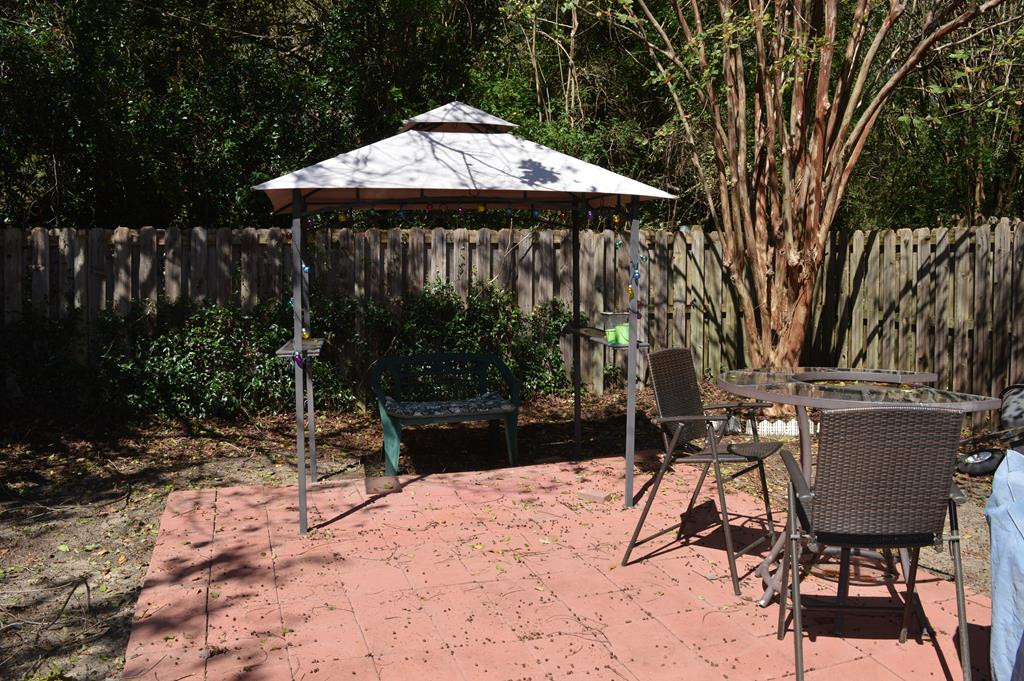 108 Raintree Court Aiken, SC 29803 - Photo 18 of 18 a patio with a table and chairs under an umbrella