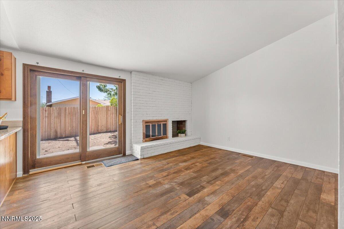 2060 Kings Row Reno, NV 89503 - Photo 11 of 37 a view of an empty room with wooden floor and a window