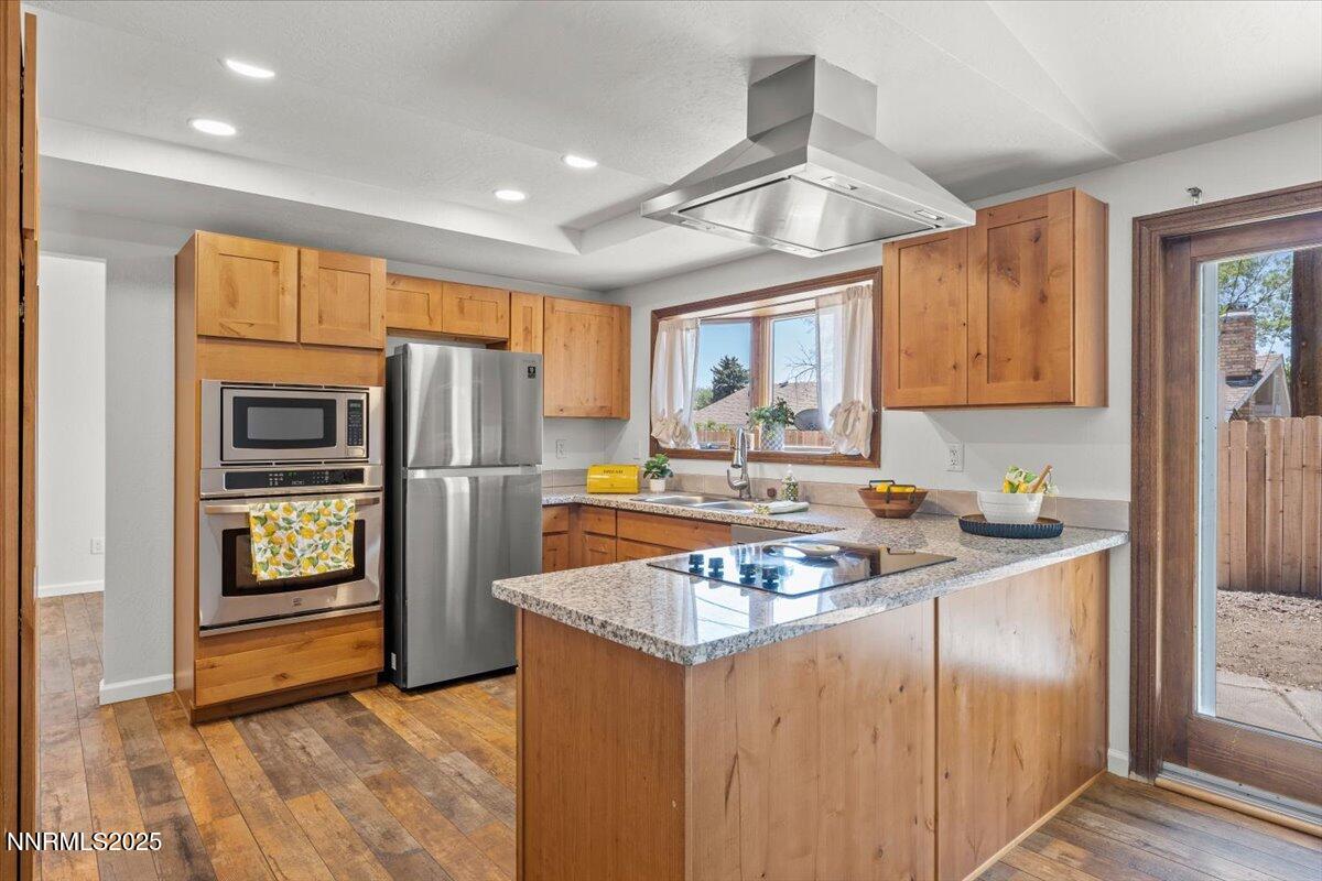 2060 Kings Row Reno, NV 89503 - Photo 2 of 37 a kitchen with granite countertop a refrigerator and a sink