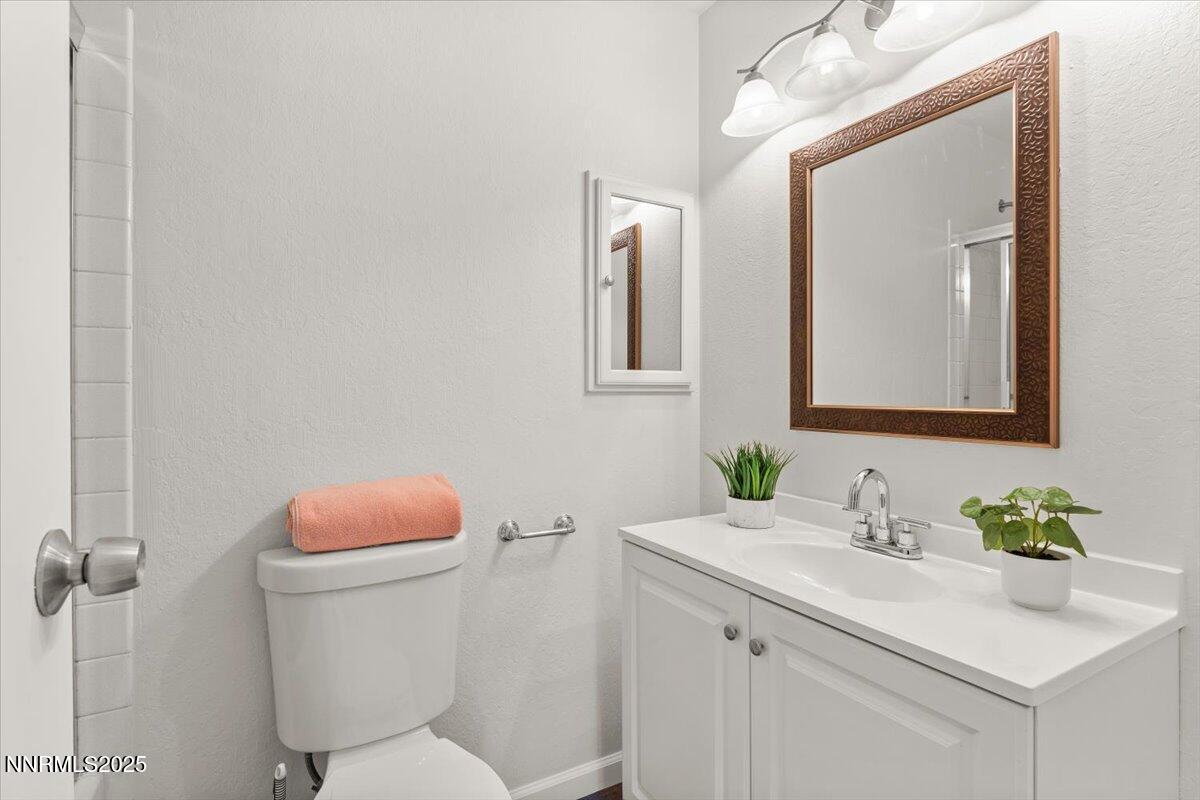2060 Kings Row Reno, NV 89503 - Photo 26 of 37 a bathroom with a sink vanity mirror and toilet