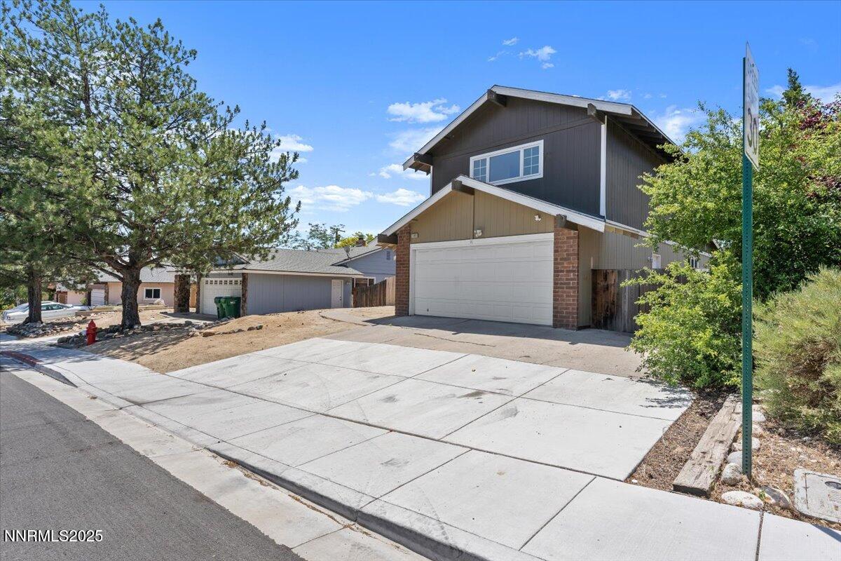 2060 Kings Row Reno, NV 89503 - Photo 33 of 37 a front view of a house with a yard and garage