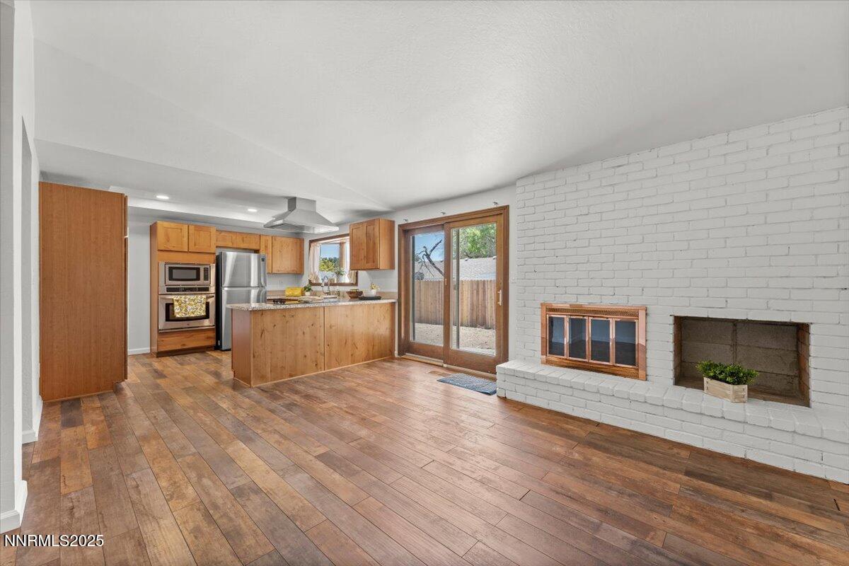 2060 Kings Row Reno, NV 89503 - Photo 7 of 37 a view of empty room with wooden floor and fireplace