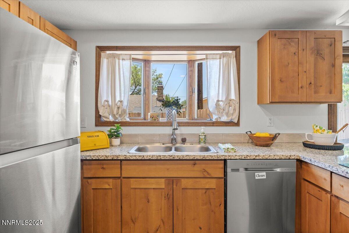 2060 Kings Row Reno, NV 89503 - Photo 9 of 37 a kitchen with a granite countertop window and a sink