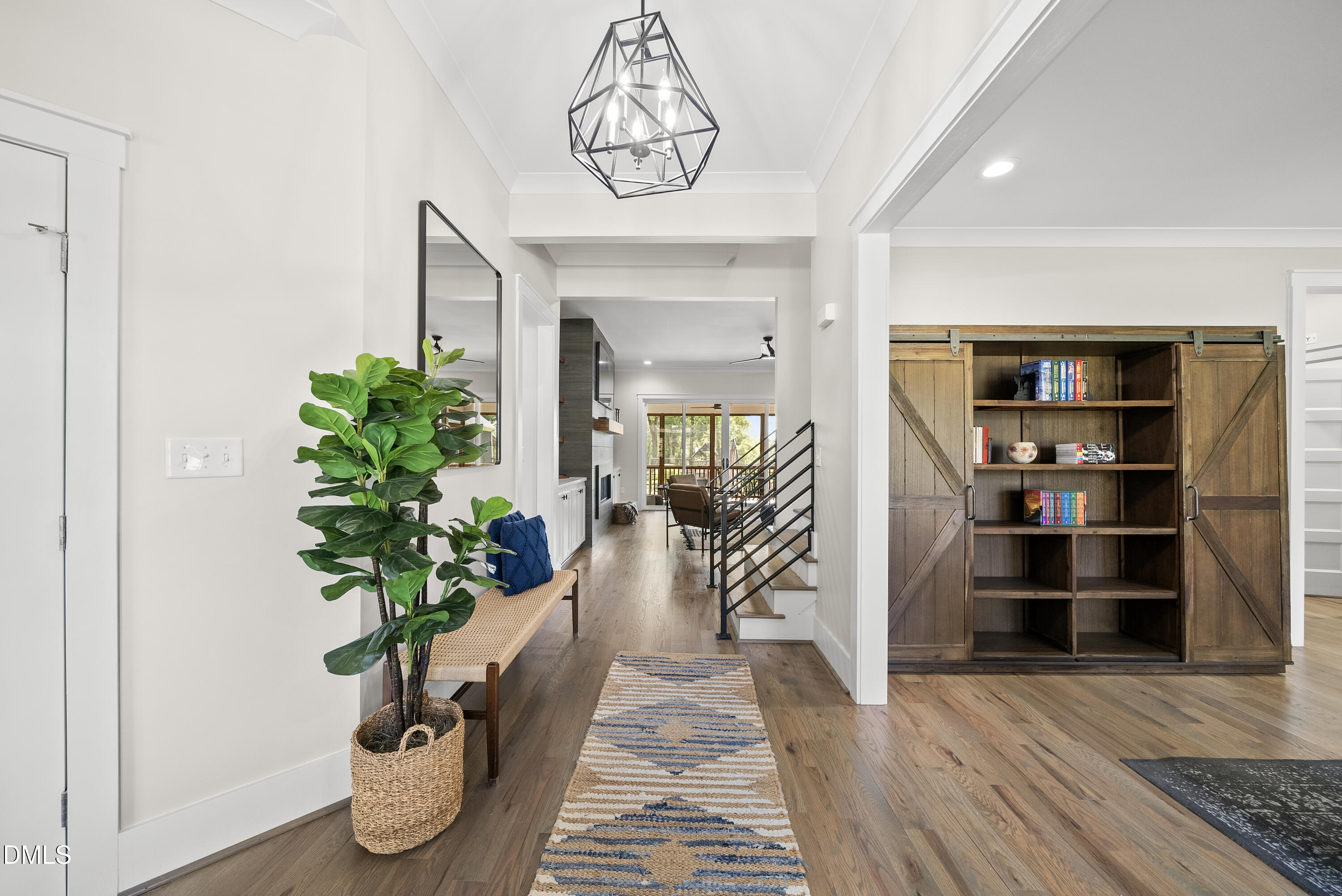 2416 Eddie Howard Road Willow Spring, NC 27592 - Photo 22 of 64 a hallway with wooden floor and a potted plant