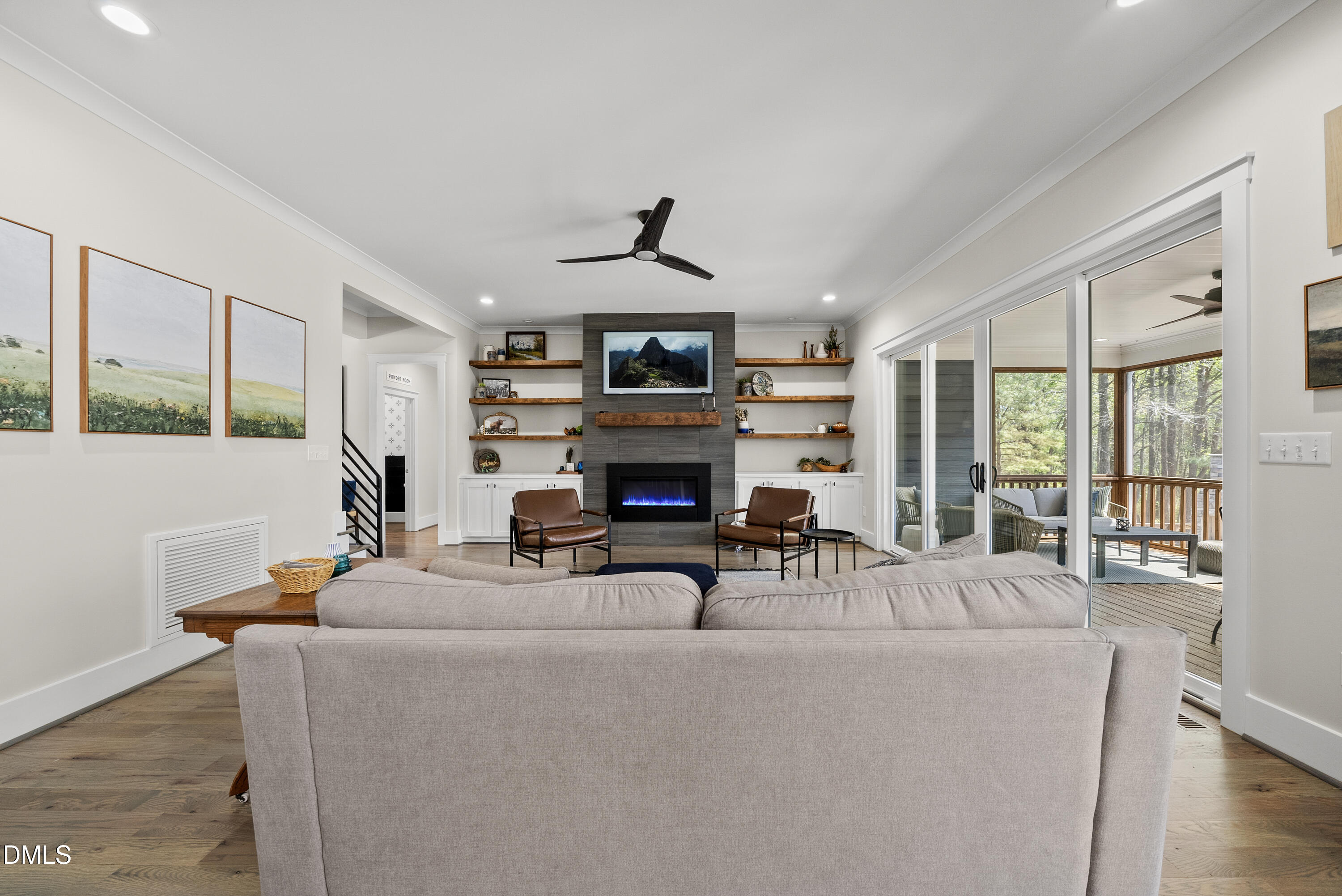 2416 Eddie Howard Road Willow Spring, NC 27592 - Photo 26 of 64 a living room with furniture a fireplace and a large window