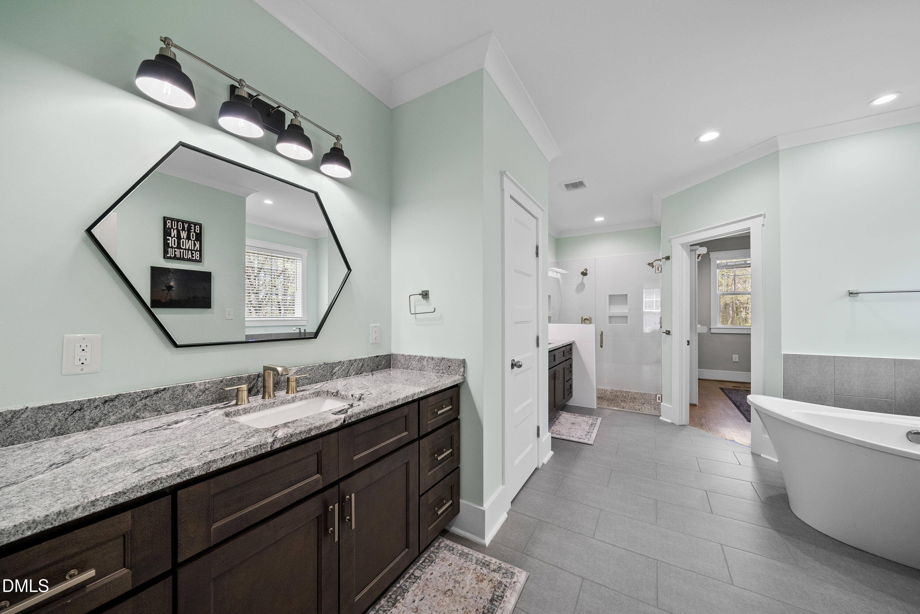 2416 Eddie Howard Road Willow Spring, NC 27592 - Photo 35 of 64 a spacious bathroom with a granite countertop double vanity sink mirror and bathtub