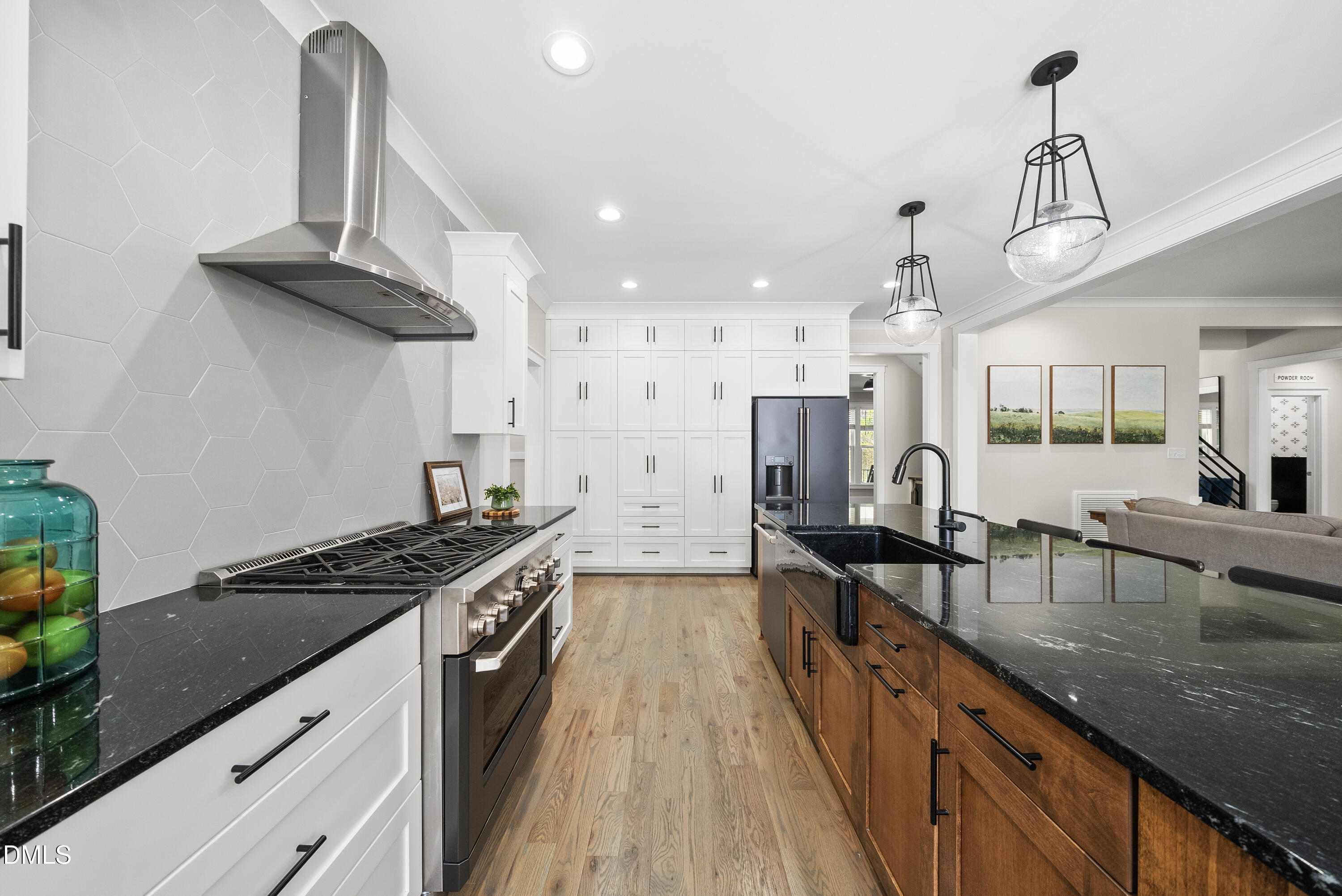 2416 Eddie Howard Road Willow Spring, NC 27592 - Photo 44 of 64 a kitchen with stainless steel appliances granite countertop a sink a stove and a wooden floors