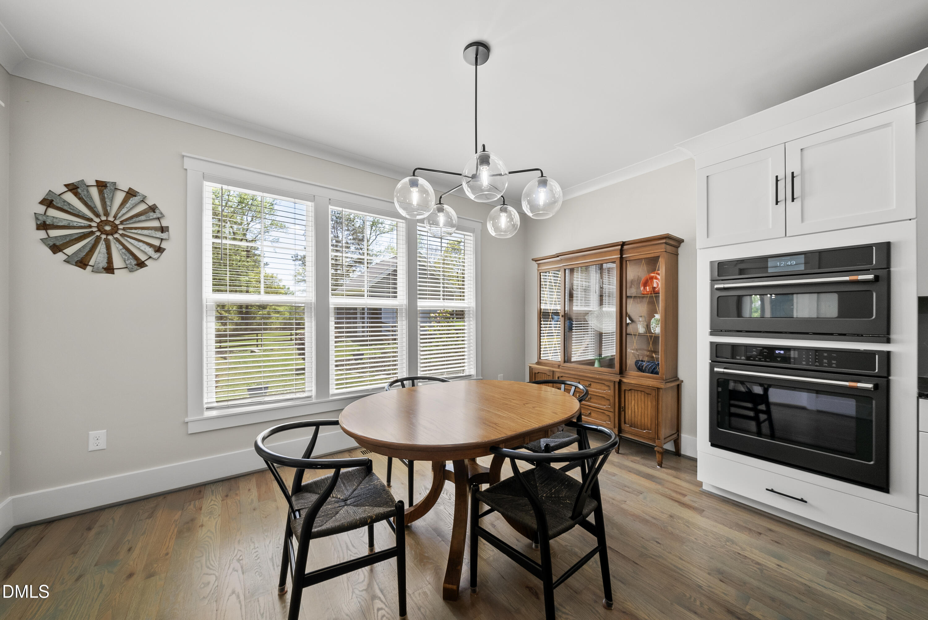 2416 Eddie Howard Road Willow Spring, NC 27592 - Photo 46 of 64 a view of a dining room with furniture window and wooden floor