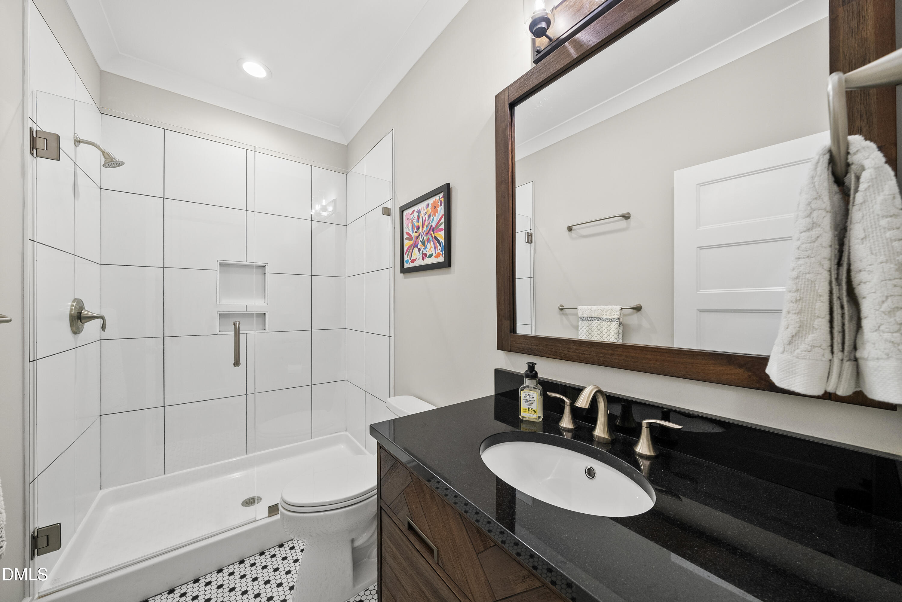 2416 Eddie Howard Road Willow Spring, NC 27592 - Photo 55 of 64 a bathroom with a granite countertop sink toilet a mirror a vanity and bathtub