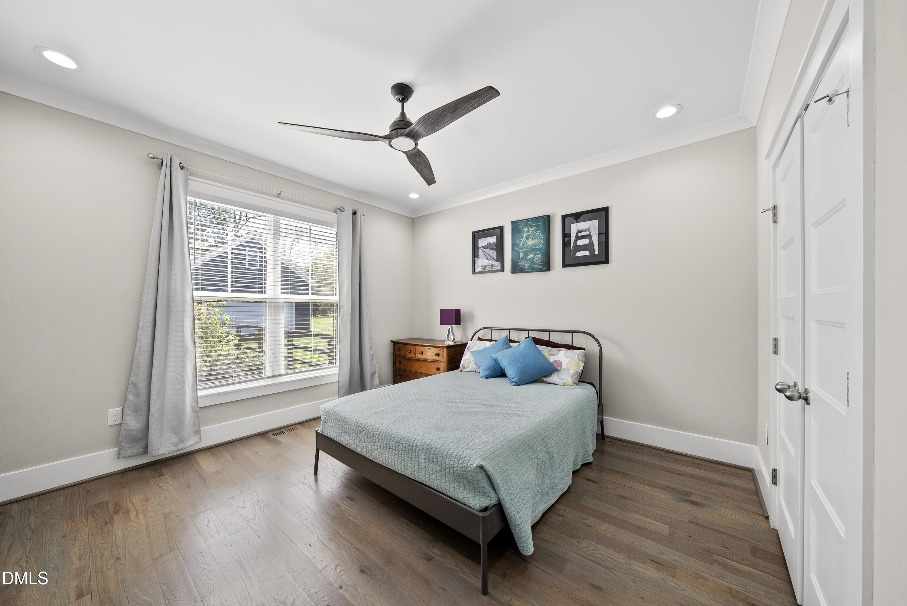 2416 Eddie Howard Road Willow Spring, NC 27592 - Photo 56 of 64 a bedroom with a bed and wooden floor