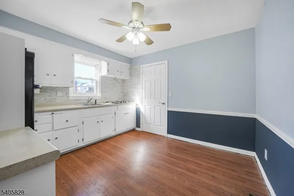 a view of a kitchen with wooden floor
