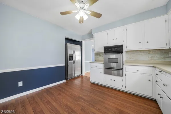 a kitchen with stainless steel appliances a refrigerator and a stove top oven