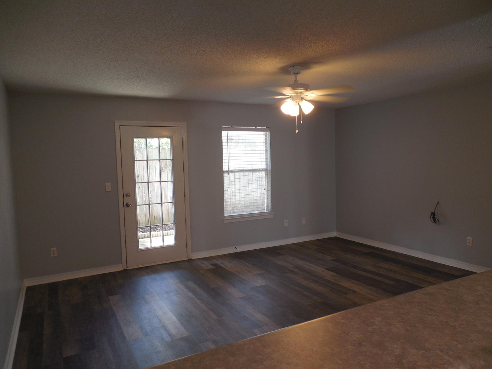 502 Keystone Road Mary Esther, FL 32569 - Photo 11 of 22 a view of an empty room with wooden floor and a window