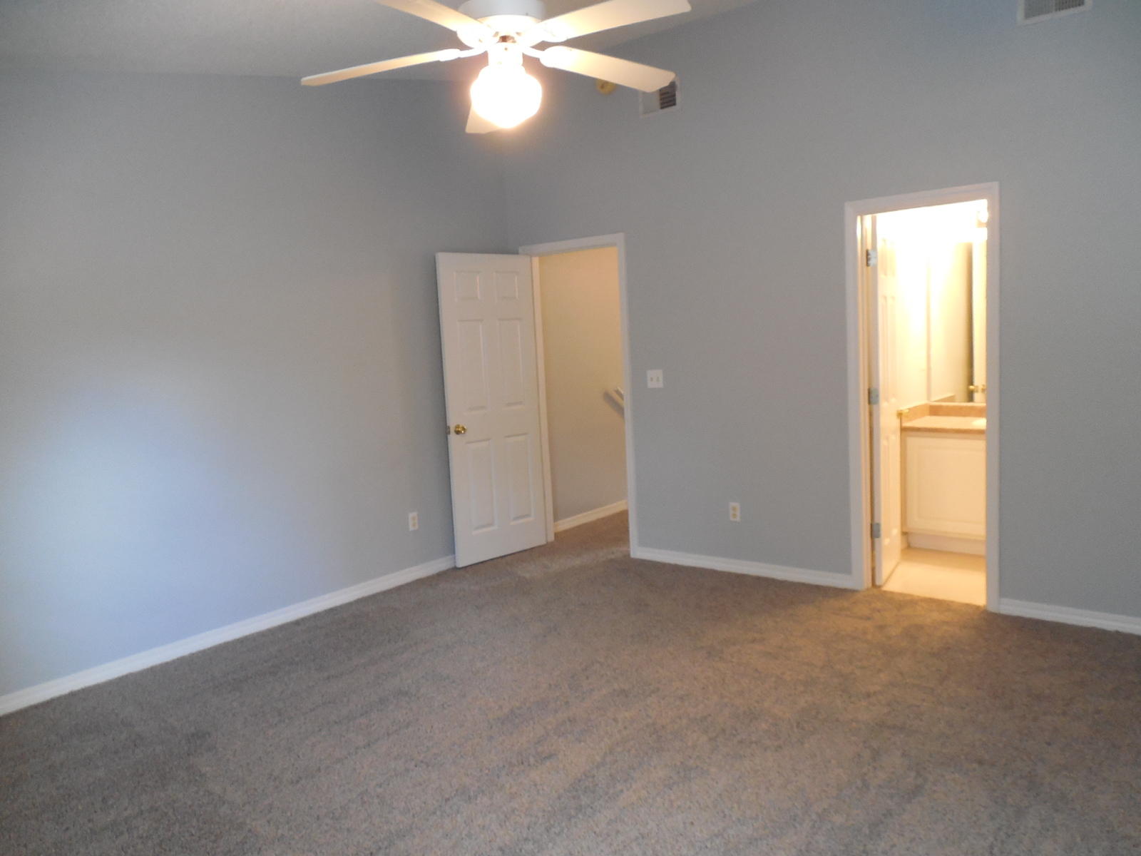 502 Keystone Road Mary Esther, FL 32569 - Photo 18 of 22 an empty room with a chandelier fan and windows