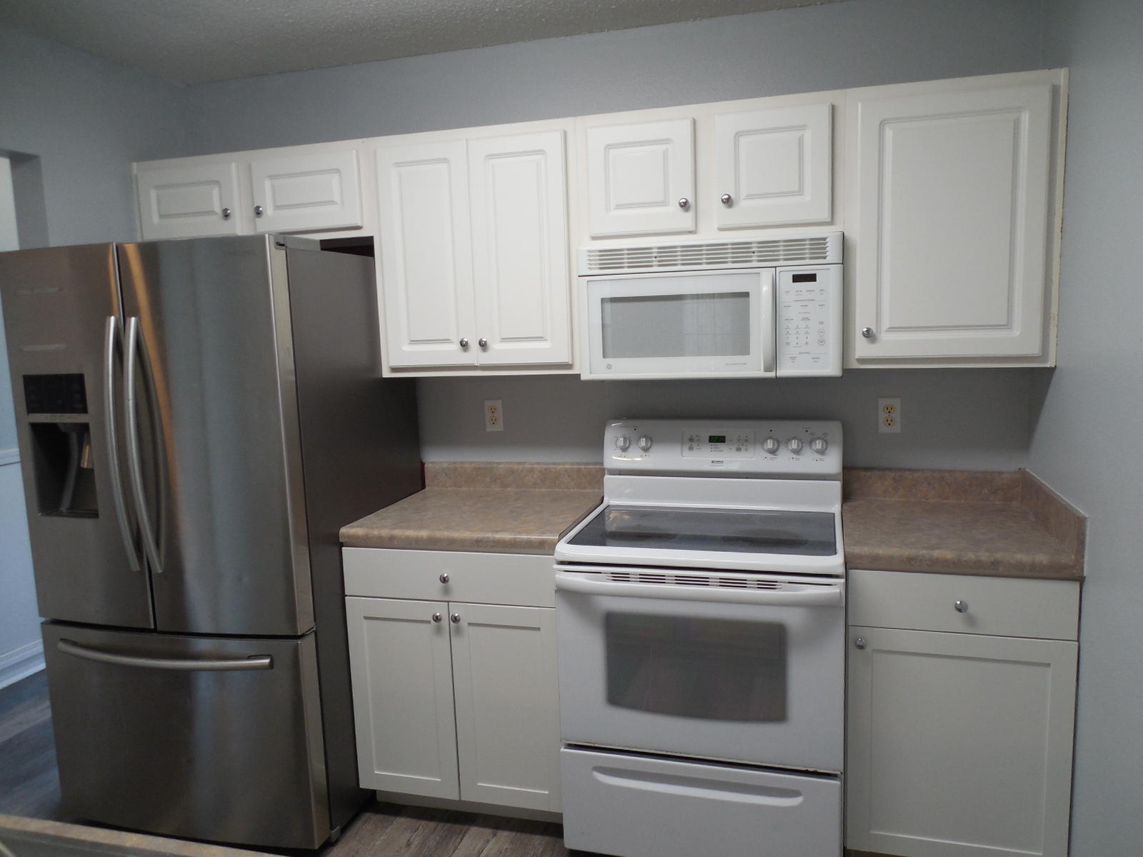 502 Keystone Road Mary Esther, FL 32569 - Photo 5 of 22 a kitchen with white cabinets and stainless steel appliances
