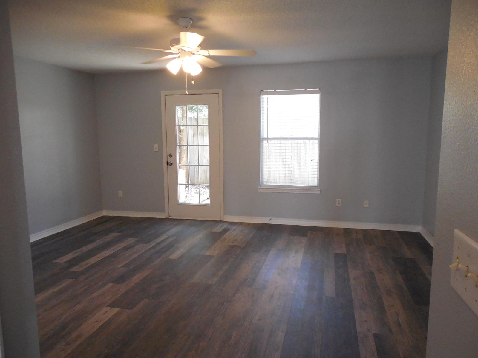 502 Keystone Road Mary Esther, FL 32569 - Photo 10 of 22 a view of an empty room with wooden floor and a window