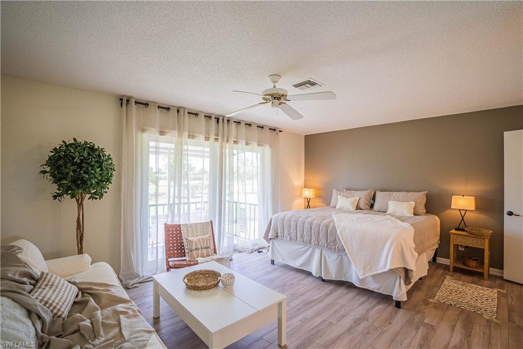 162 Teryl Road, Unit 4 Naples, FL 34112 - Photo 11 of 20 a bedroom with a bed and a couch