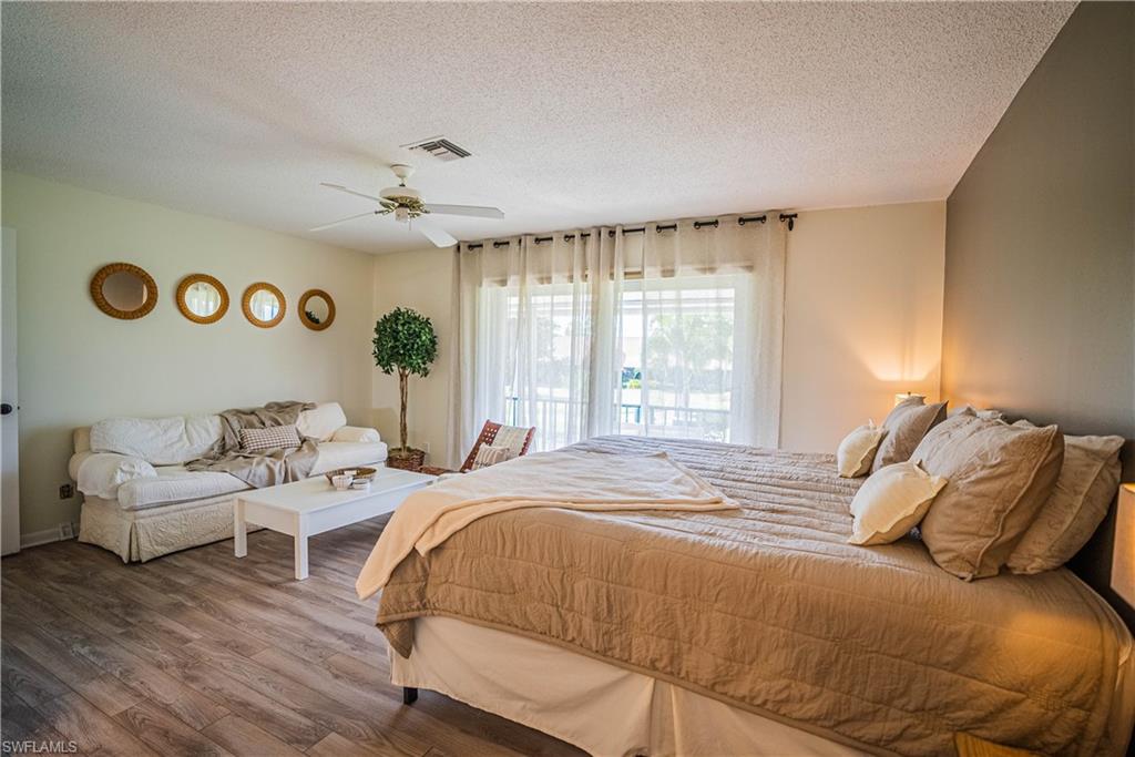162 Teryl Road, Unit 4 Naples, FL 34112 - Photo 12 of 20 a bedroom with a bed and a large window