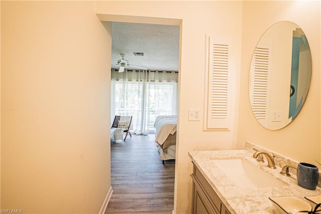 162 Teryl Road, Unit 4 Naples, FL 34112 - Photo 13 of 20 a bathroom with a tub sink and mirror
