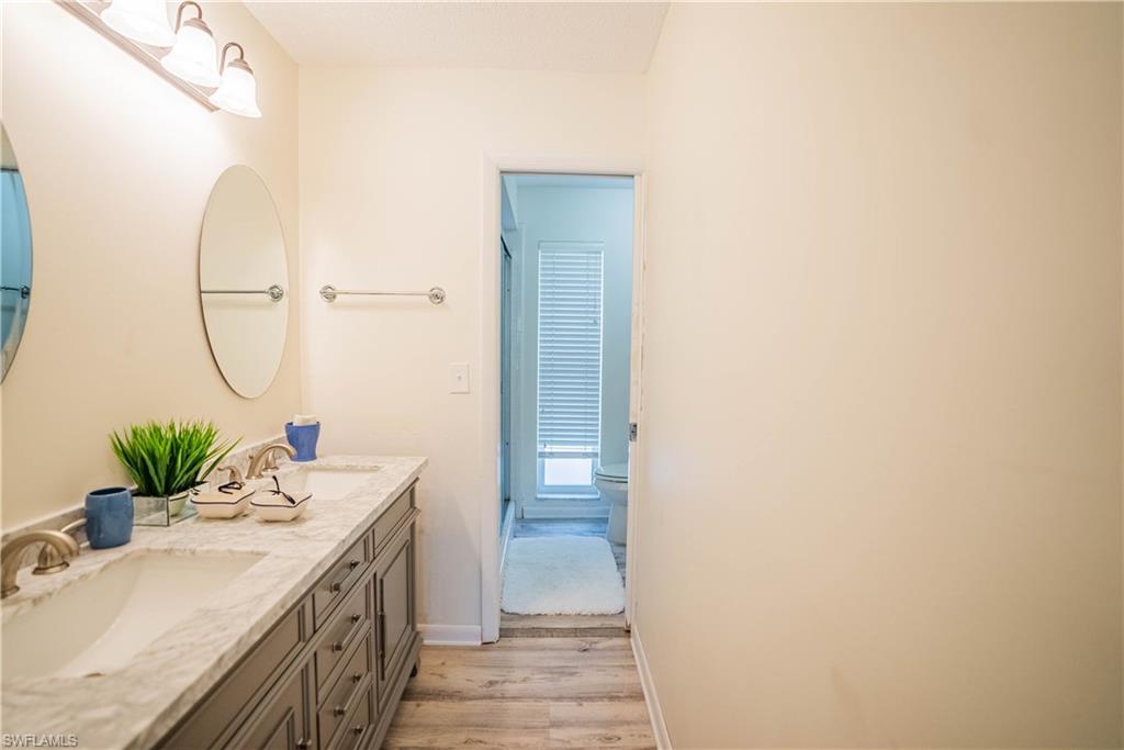 162 Teryl Road, Unit 4 Naples, FL 34112 - Photo 14 of 20 a bathroom with a double vanity sink and a mirror