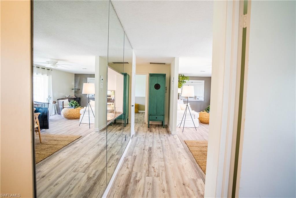 162 Teryl Road, Unit 4 Naples, FL 34112 - Photo 15 of 20 a hallway with a view of living room with furniture