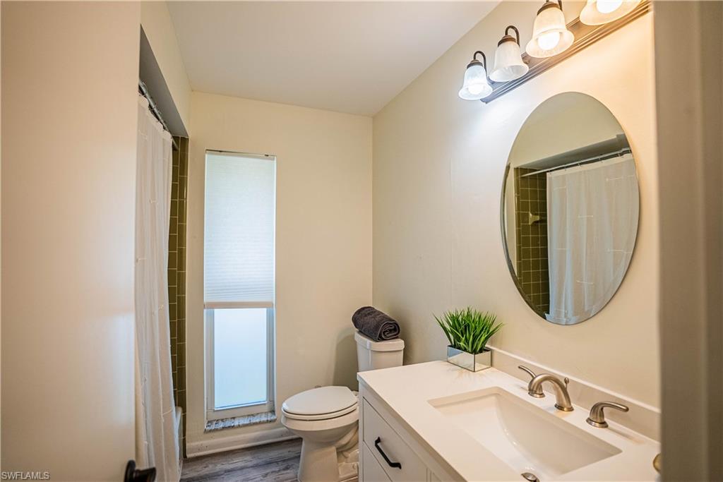 162 Teryl Road, Unit 4 Naples, FL 34112 - Photo 20 of 20 a bathroom with a toilet sink and mirror