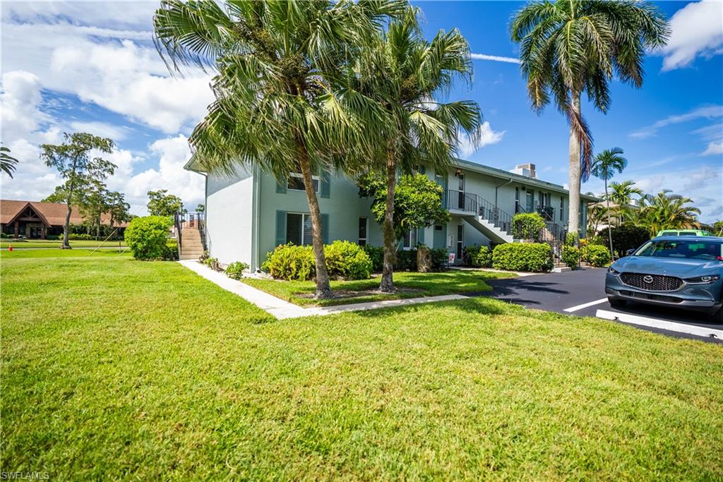 162 Teryl Road, Unit 4 Naples, FL 34112 - Photo 3 of 20 a view of a house with swimming pool and next to a yard