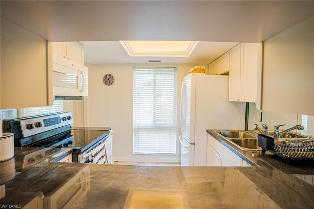 162 Teryl Road, Unit 4 Naples, FL 34112 - Photo 4 of 20 a living room with a bed furniture and a window