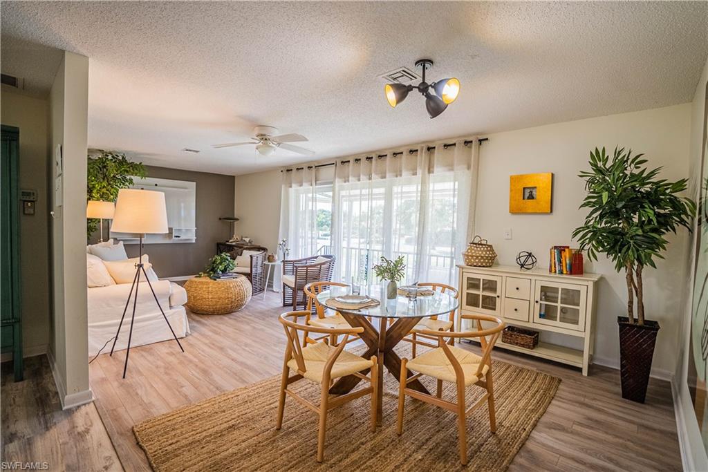 162 Teryl Road, Unit 4 Naples, FL 34112 - Photo 7 of 20 a view of a dining room with furniture window and wooden floor