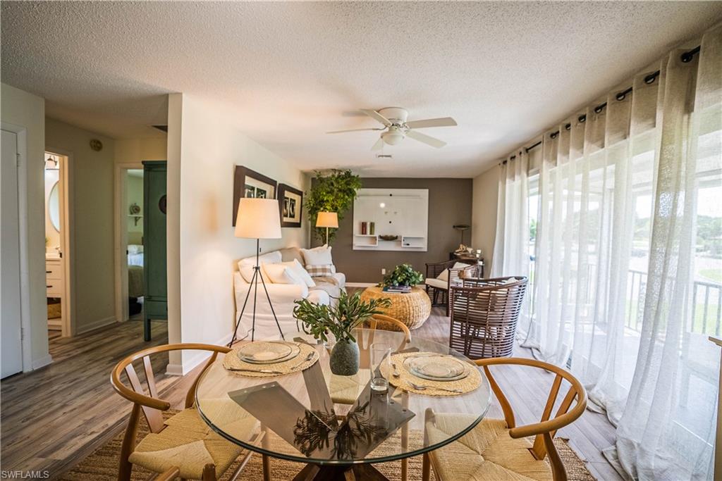 162 Teryl Road, Unit 4 Naples, FL 34112 - Photo 8 of 20 a view of a dining room with furniture window and wooden floor