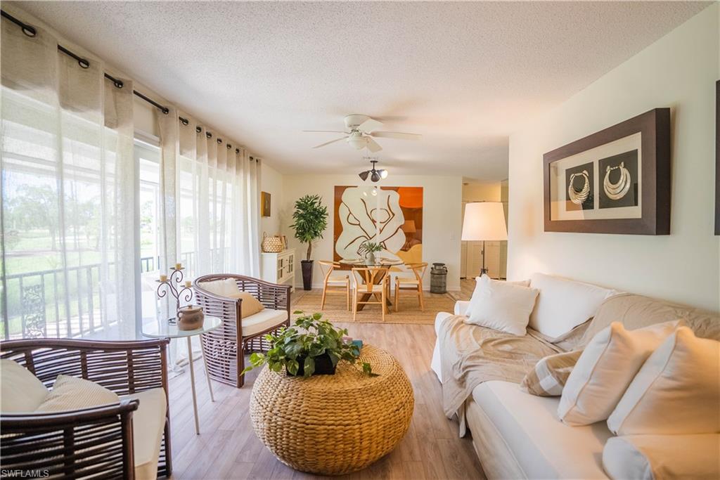 162 Teryl Road, Unit 4 Naples, FL 34112 - Photo 9 of 20 a living room with furniture and a large window