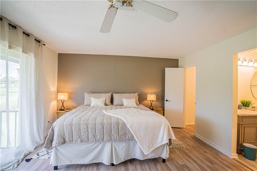 162 Teryl Road, Unit 4 Naples, FL 34112 - Photo 10 of 20 a bedroom with a bed and a flat tv screen on dresser