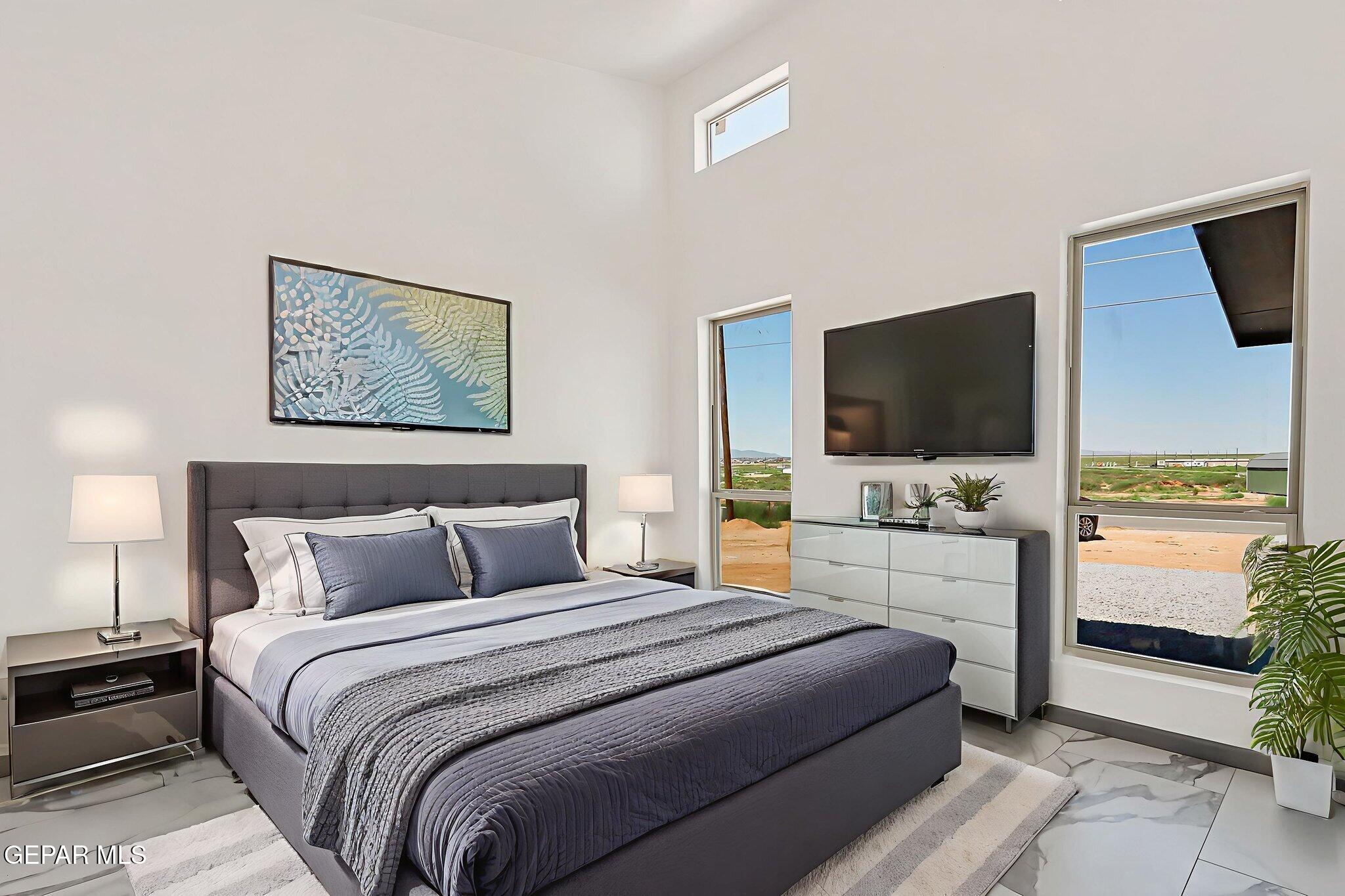 693 San Jose Chaparral, NM 88081 - Photo 23 of 40 a bedroom with a bed and a flat screen tv