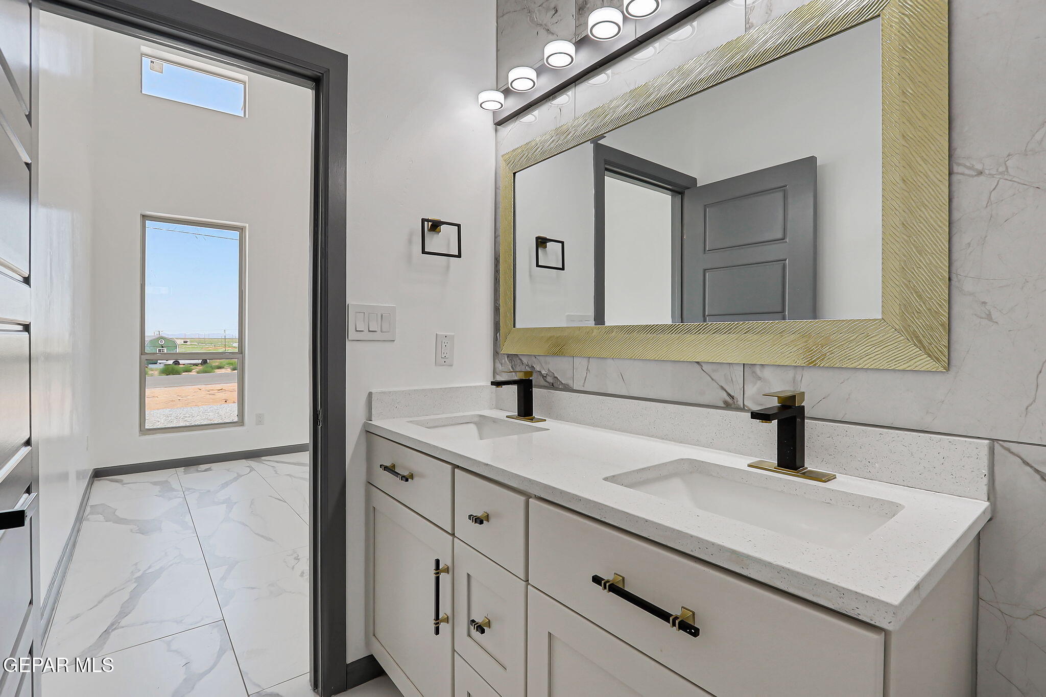 693 San Jose Chaparral, NM 88081 - Photo 24 of 40 a bathroom with a sink vanity and a mirror