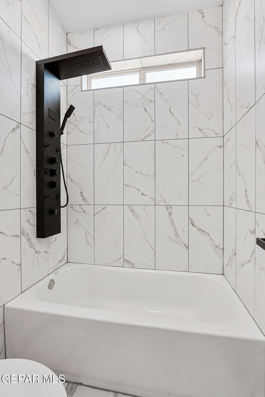 693 San Jose Chaparral, NM 88081 - Photo 32 of 40 a bathroom with a bathtub and a shower