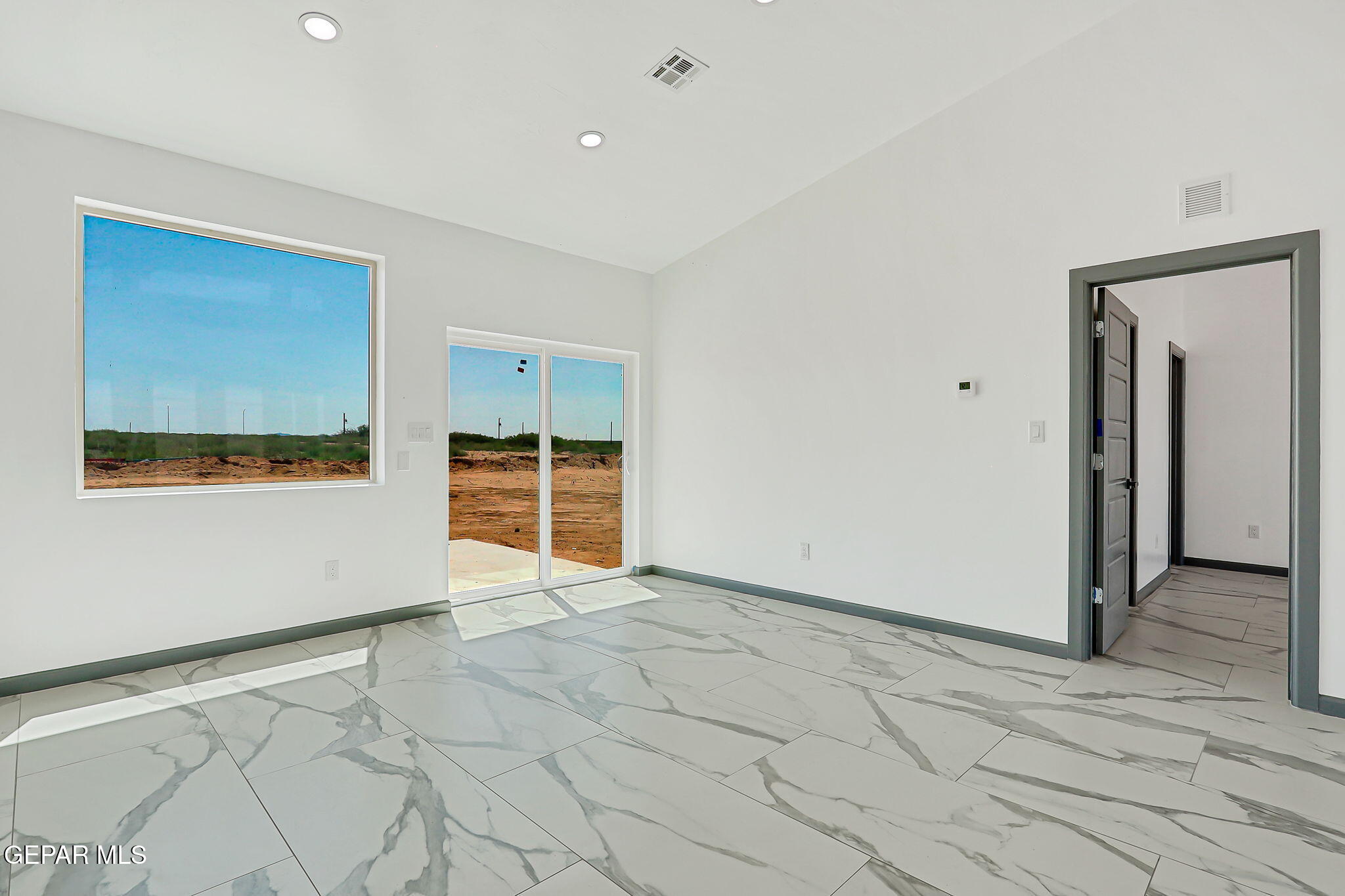 693 San Jose Chaparral, NM 88081 - Photo 38 of 40 a view of an empty room with wooden floor and a window