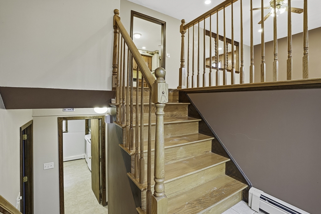 4 Carby Drive Mendon, MA 01756 - Photo 22 of 35 a view of staircase with lots of frames on wall and a window
